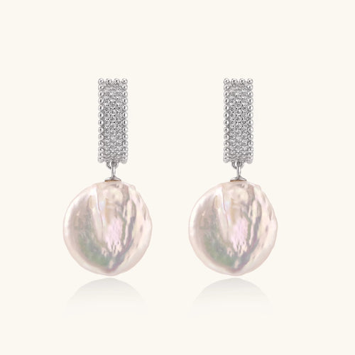 Rhodium-plated silver curved stud with pave stones and baroque pearl drop on white background