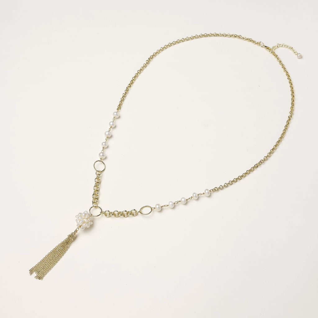 Long gold-plated necklace with freshwater pearls, chunky chain links, and flowing tassel pendant