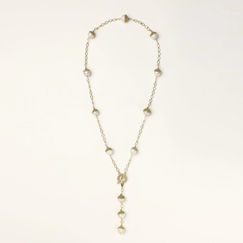 Gold-plated lariat necklace with baroque pearls and textured caps on cream background, showing adjustable Y-shaped design.