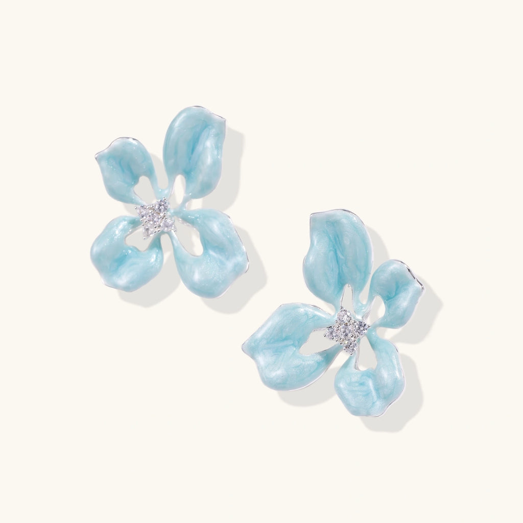 Turquoise enamel flower stud earrings with marbled finish and crystal centers on 18K gold plated brass