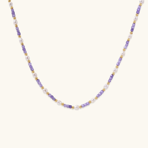 Delicate 18K gold vermeil necklace with alternating lavender zirconia beads and white freshwater pearls on cream background